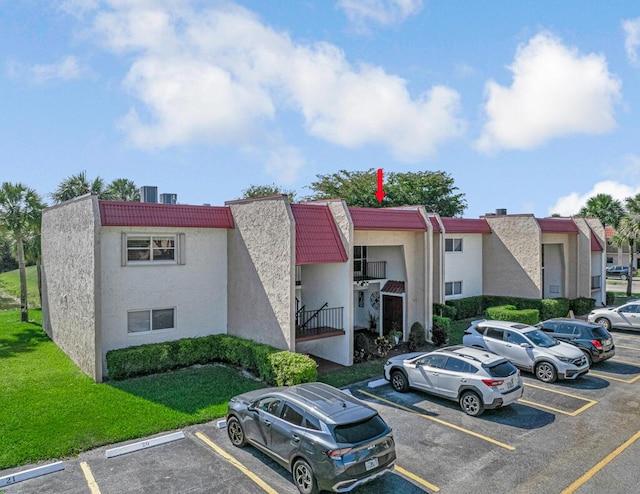 176 Lake Carol Dr, West Palm Beach, FL 33411 - view of property with uncovered parking