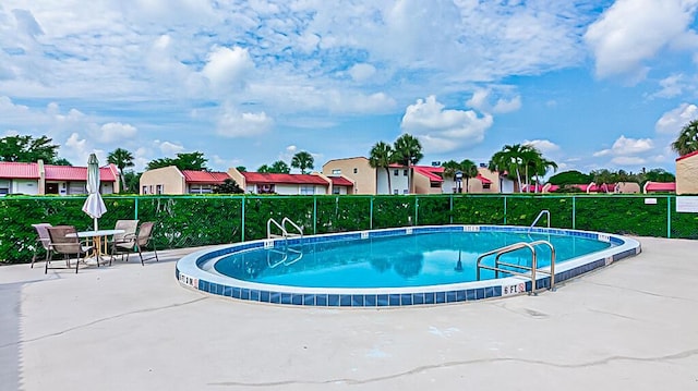 176 Lake Carol Dr, West Palm Beach, FL 33411 - pool featuring fence, a residential view, and a patio