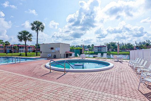 176 Lake Carol Dr, West Palm Beach, FL 33411 - community pool featuring fence, a patio area, and a hot tub
