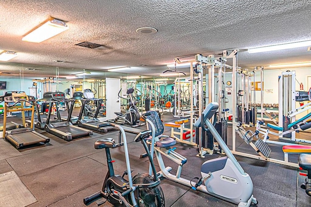 176 Lake Carol Dr, West Palm Beach, FL 33411 - gym with visible vents and a textured ceiling