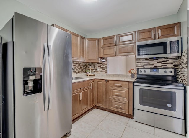 176 Lake Carol Dr, West Palm Beach, FL 33411 - kitchen with light countertops, backsplash, stainless steel appliances, and light tile patterned floors