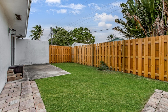 view of yard featuring a patio area and a fenced backyard
