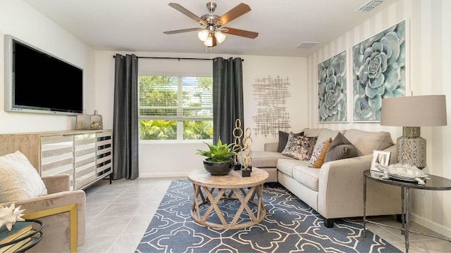 tiled living room with ceiling fan, baseboards, and visible vents