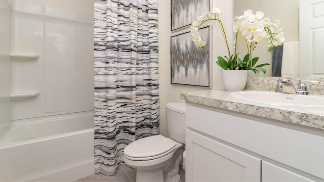 full bathroom featuring vanity, tile patterned flooring, and toilet