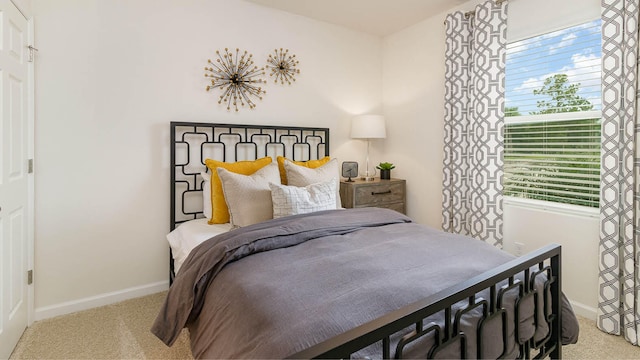 bedroom with baseboards and carpet flooring