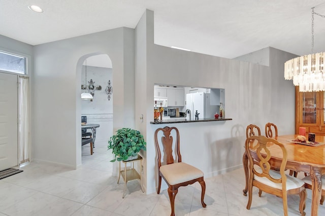 7829 Mansfield Hollow Rd, Delray Beach, FL 33446 - dining room with arched walkways and a chandelier