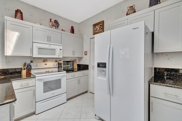 7829 Mansfield Hollow Rd, Delray Beach, FL 33446 - kitchen with dark stone counters, marble finish floor, white appliances, and white cabinets
