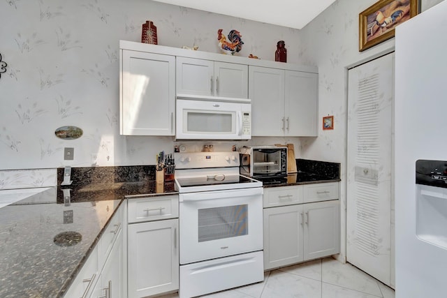 7829 Mansfield Hollow Rd, Delray Beach, FL 33446 - kitchen featuring wallpapered walls, a toaster, dark stone countertops, white appliances, and white cabinetry