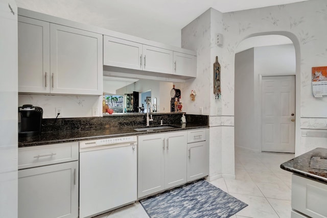 7829 Mansfield Hollow Rd, Delray Beach, FL 33446 - kitchen with white dishwasher, dark stone countertops, white cabinetry, and a sink