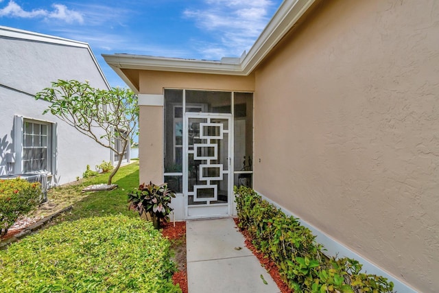 7829 Mansfield Hollow Rd, Delray Beach, FL 33446 - doorway to property featuring a yard and stucco siding