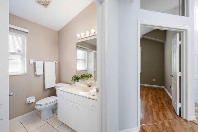full bath with a wealth of natural light, visible vents, toilet, and vanity