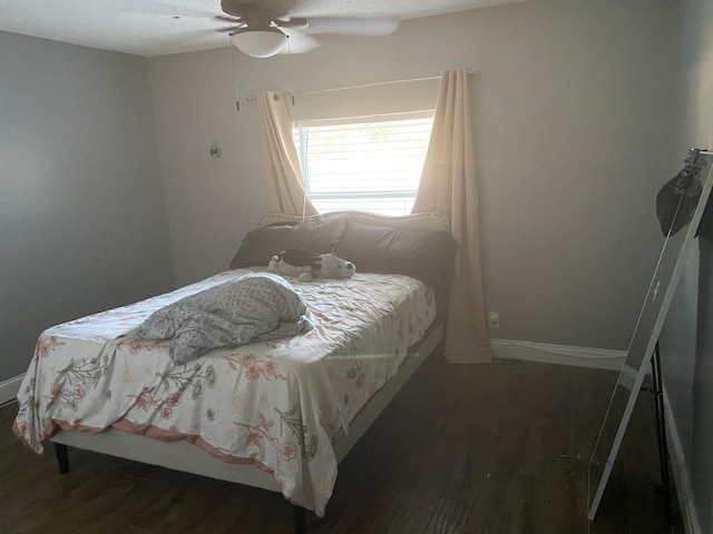 bedroom with wood finished floors, a ceiling fan, and baseboards