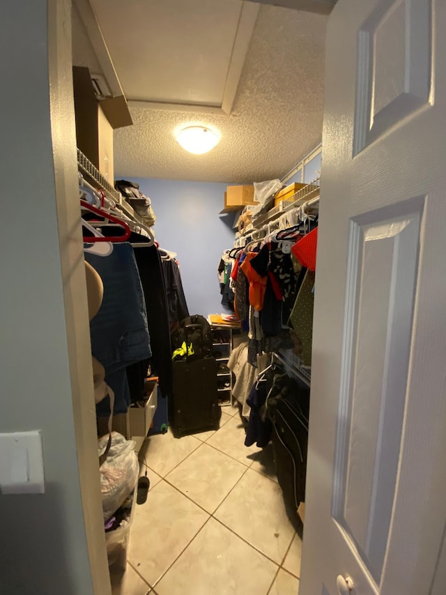 spacious closet featuring light tile patterned floors