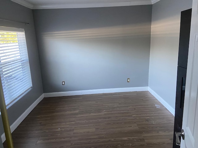 unfurnished room featuring baseboards, ornamental molding, and dark wood-style floors