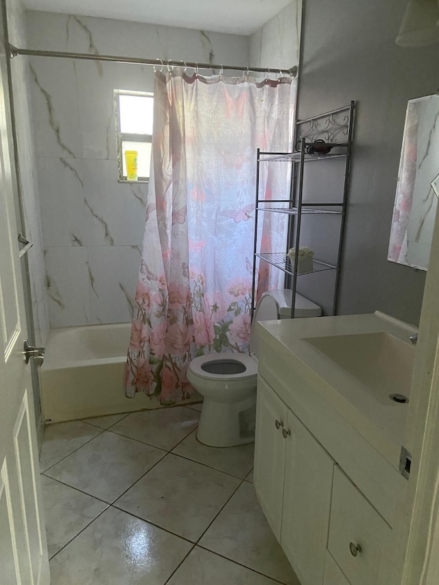 bathroom featuring shower / bath combo with shower curtain, vanity, tile patterned flooring, and toilet