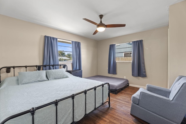 1728 SE Harrison St, Stuart, FL 34997 - bedroom with baseboards, a ceiling fan, and wood finished floors