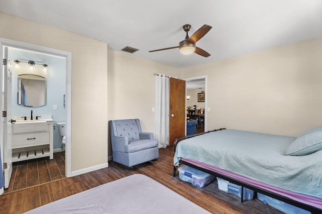 1728 SE Harrison St, Stuart, FL 34997 - bedroom featuring ceiling fan, visible vents, wood finished floors, a sink, and baseboards