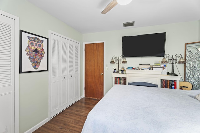 1728 SE Harrison St, Stuart, FL 34997 - bedroom featuring ceiling fan, visible vents, baseboards, two closets, and dark wood-style floors