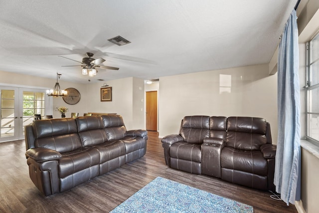 1728 SE Harrison St, Stuart, FL 34997 - living area featuring french doors, ceiling fan with notable chandelier, wood finished floors, and visible vents