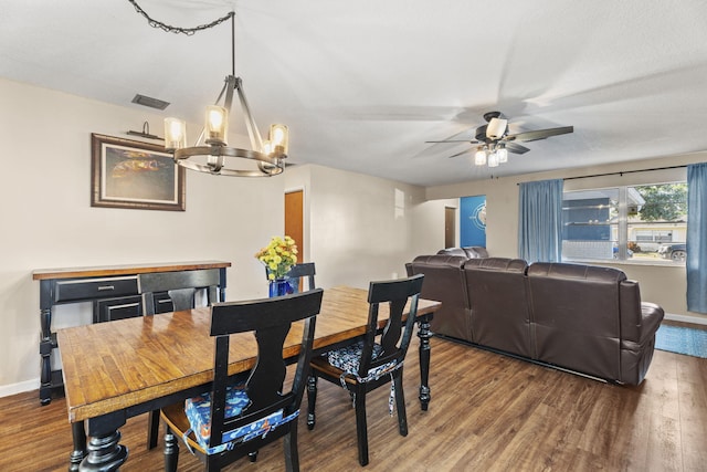 1728 SE Harrison St, Stuart, FL 34997 - dining area featuring baseboards, ceiling fan with notable chandelier, wood finished floors, and visible vents