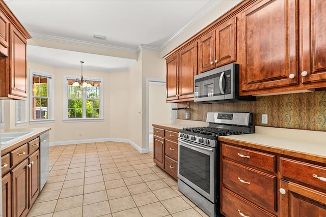 kitchen featuring light countertops, baseboards, appliances with stainless steel finishes, and an inviting chandelier