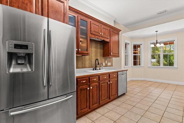 kitchen with light countertops, a chandelier, a sink, appliances with stainless steel finishes, and light tile patterned floors
