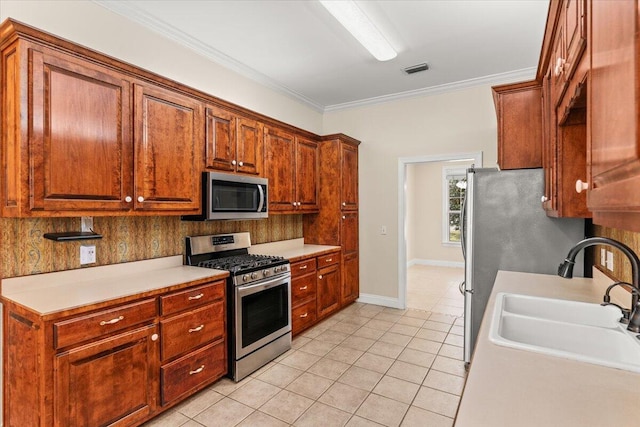 kitchen with visible vents, appliances with stainless steel finishes, a sink, light countertops, and light tile patterned flooring