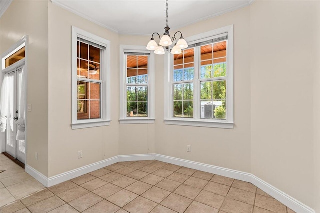 unfurnished dining area with light tile patterned floors, baseboards, an inviting chandelier, and crown molding
