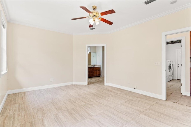 spare room with washing machine and clothes dryer, a ceiling fan, crown molding, and baseboards