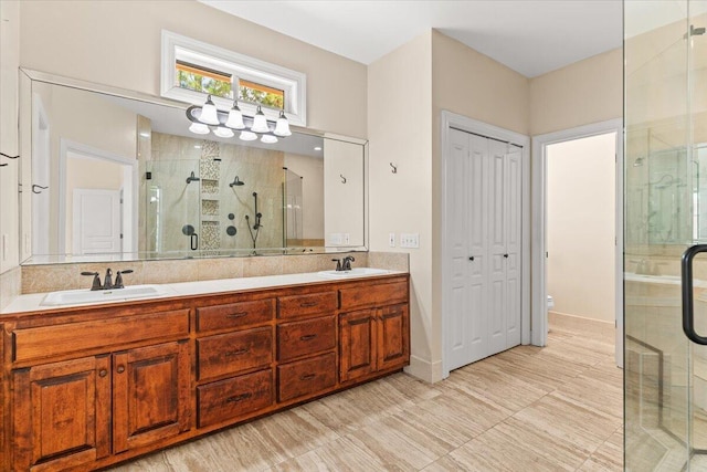 full bathroom with double vanity, a sink, toilet, and a shower stall