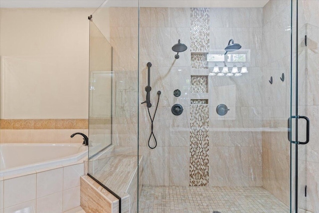 bathroom featuring a stall shower and a bath