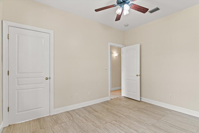 unfurnished bedroom featuring baseboards, ceiling fan, and visible vents