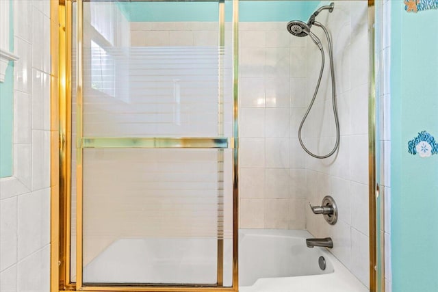 bathroom featuring combined bath / shower with glass door