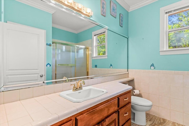 bathroom with crown molding, vanity, toilet, tile walls, and a shower stall