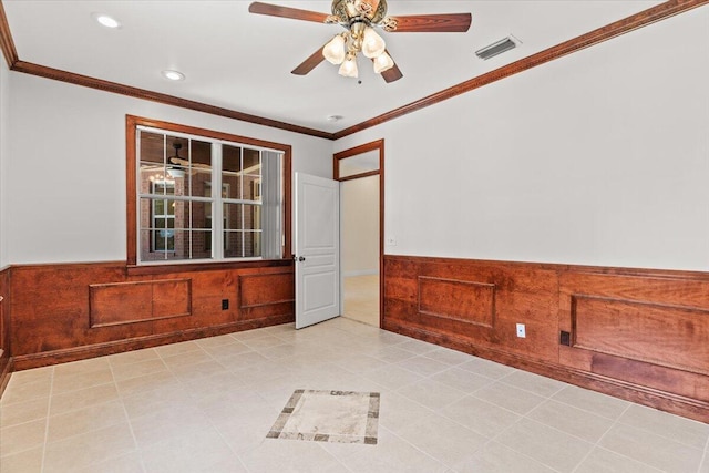unfurnished room with visible vents, crown molding, wainscoting, recessed lighting, and a ceiling fan