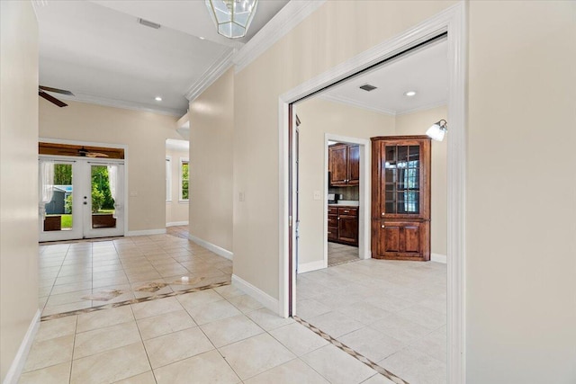entryway with baseboards, ornamental molding, light tile patterned floors, and french doors
