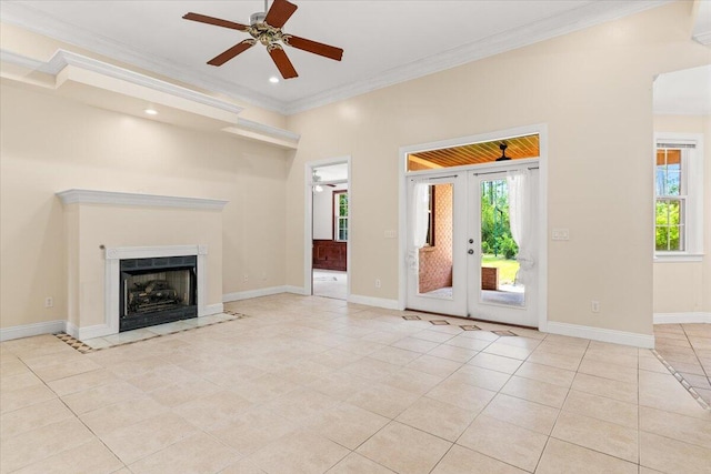 unfurnished living room with crown molding, light tile patterned floors, ceiling fan, and a wealth of natural light