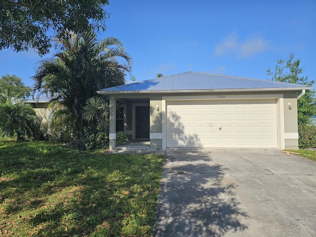 7745 99th Ct, Vero Beach, FL 32967 - single story home with stucco siding, metal roof, a front yard, concrete driveway, and an attached garage