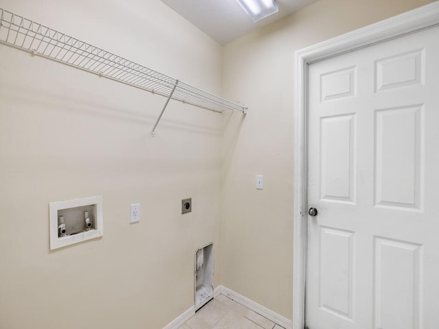 7745 99th Ct, Vero Beach, FL 32967 - clothes washing area featuring hookup for a washing machine, laundry area, light tile patterned floors, hookup for an electric dryer, and baseboards