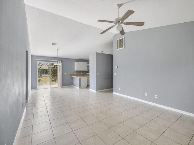 7745 99th Ct, Vero Beach, FL 32967 - unfurnished living room featuring light tile patterned floors, visible vents, ceiling fan, and vaulted ceiling