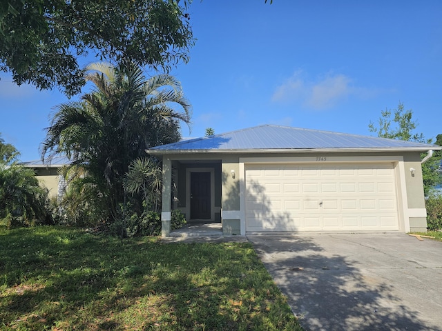 7745 99th Ct, Vero Beach, FL 32967 - ranch-style house with metal roof, concrete driveway, an attached garage, and stucco siding