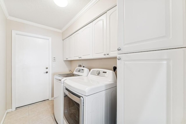 376 SW Quiet Woods, Port Saint Lucie, FL 34953 - laundry area featuring cabinet space, crown molding, baseboards, light tile patterned floors, and washer and clothes dryer
