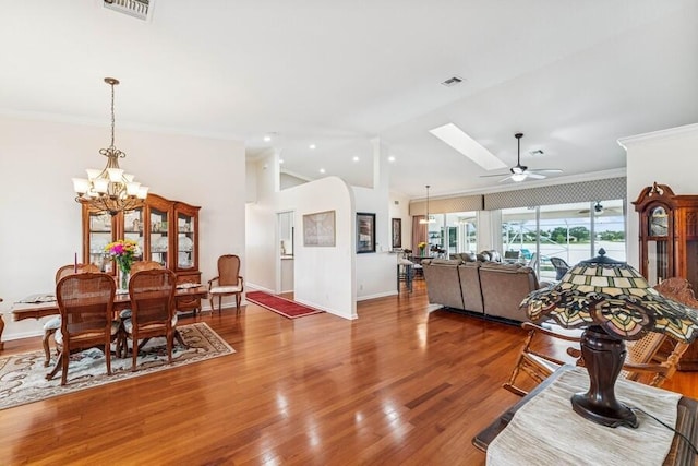 376 SW Quiet Woods, Port Saint Lucie, FL 34953 - dining area with crown molding, ceiling fan with notable chandelier, and wood finished floors
