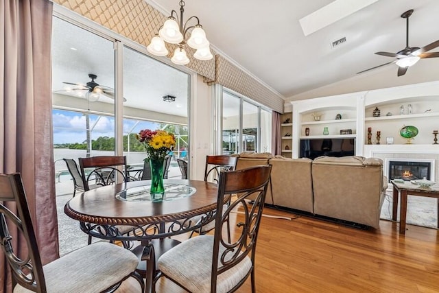 376 SW Quiet Woods, Port Saint Lucie, FL 34953 - dining space with a ceiling fan, visible vents, vaulted ceiling with skylight, and light wood-style floors
