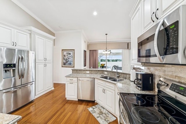 376 SW Quiet Woods, Port Saint Lucie, FL 34953 - kitchen featuring a sink, tasteful backsplash, white cabinets, and stainless steel appliances