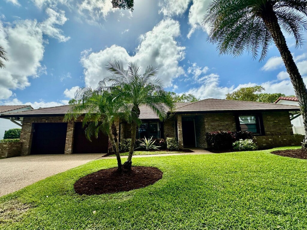 3901 NW 27th Ave, Boca Raton, FL 33434 - single story home featuring an attached garage, a front yard, and driveway