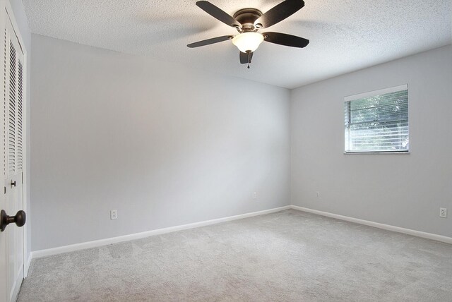 5620 SE Paramount Dr, Stuart, FL 34997 - carpeted empty room featuring a ceiling fan, a textured ceiling, and baseboards