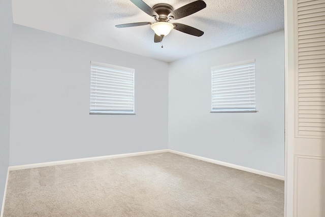 5620 SE Paramount Dr, Stuart, FL 34997 - carpeted spare room with a textured ceiling, ceiling fan, and baseboards