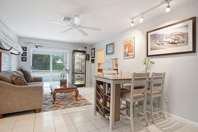 5620 SE Paramount Dr, Stuart, FL 34997 - dining room with track lighting, light tile patterned floors, visible vents, a ceiling fan, and a textured ceiling