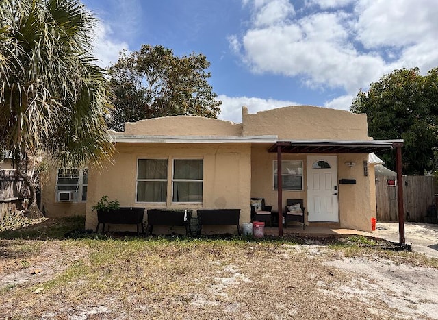 508 Palmetto St, West Palm Beach, FL 33405 - view of front of home with stucco siding and fence
